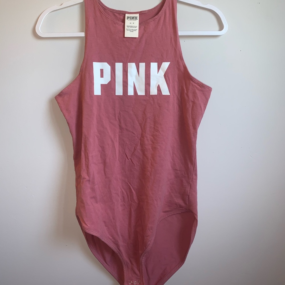 Pink high neck body suit.